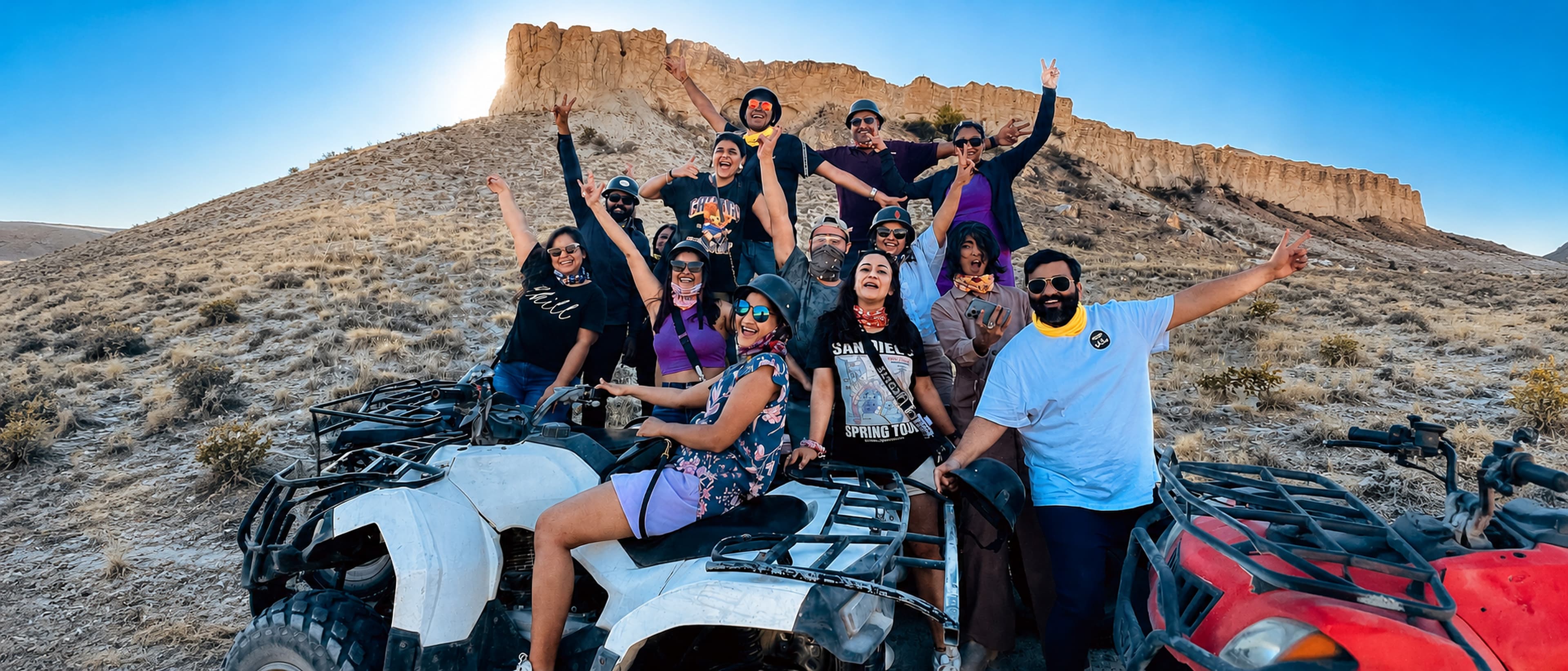 Bucketlist tribe celebrating on ATVs in the desert